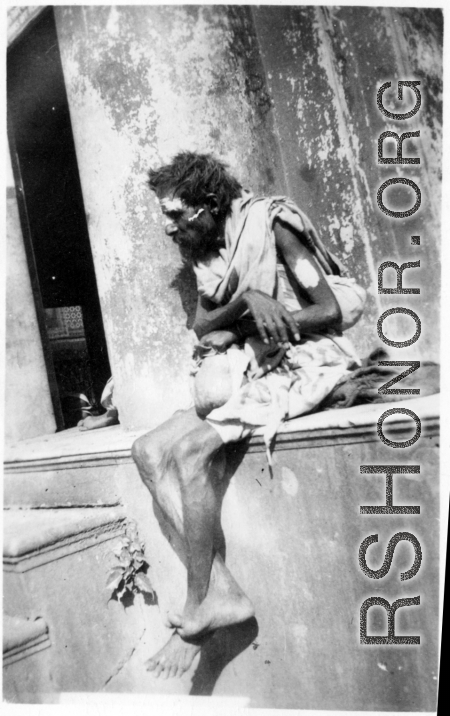 Man begs on road in town in Burma or India.  Near the 797th Engineer Forestry Company.  During WWII.