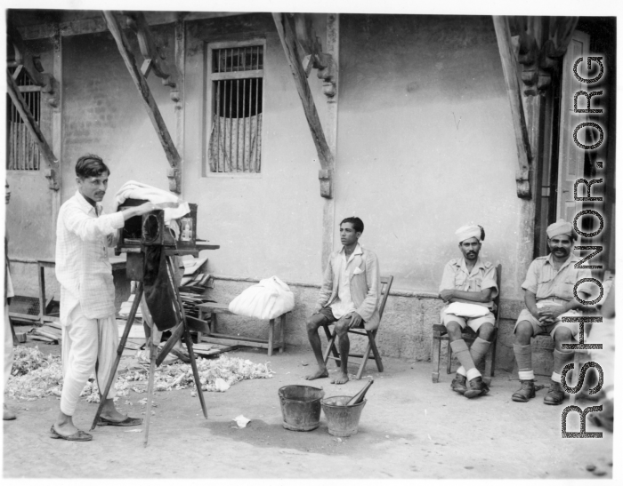 Local Indian photographer at work.  Scenes in India witnessed by American GIs during WWII. For many Americans of that era, with their limited experience traveling, the everyday sights and sounds overseas were new, intriguing, and photo worthy.