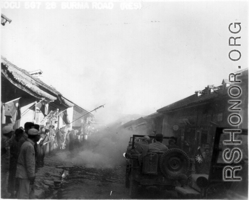 American jeeps run gauntlet of fireworks in Chinese town.