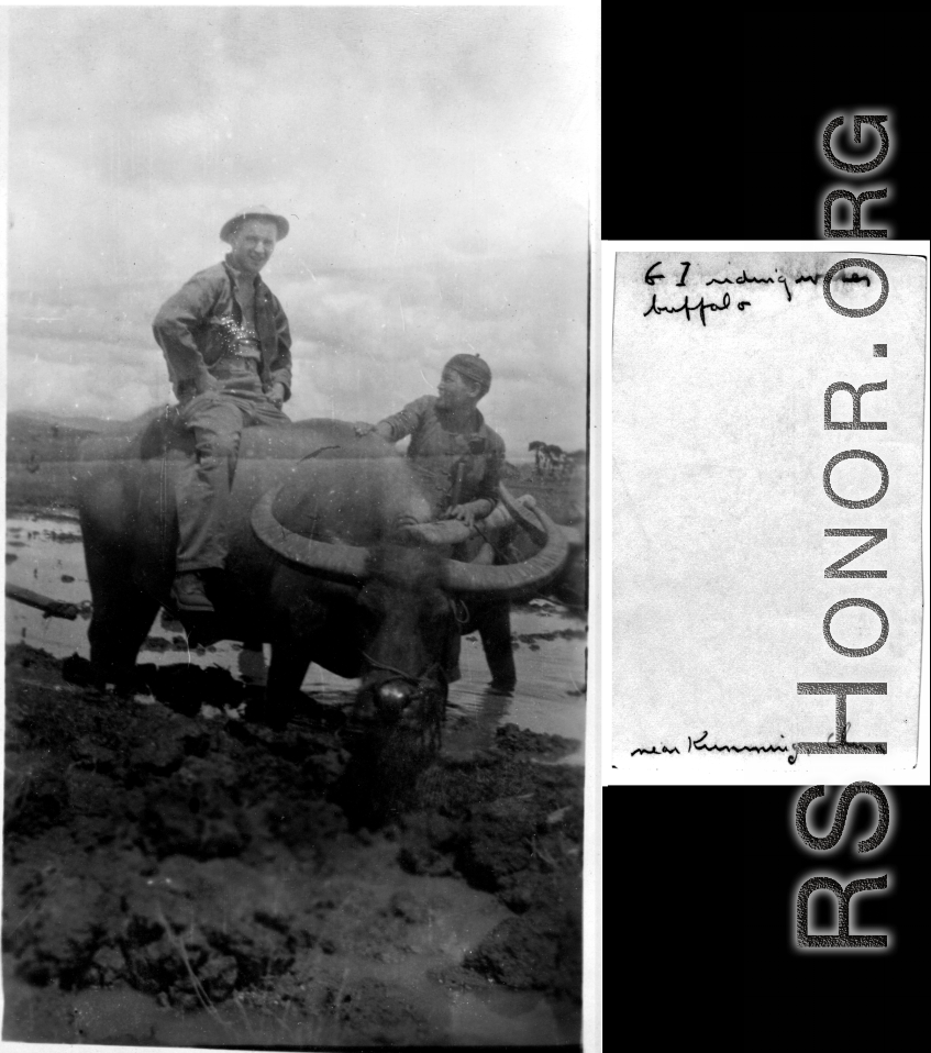 GI riding water buffalo near Kunming, China, during WWII, while young Chinese farmer helps (and tolerates).