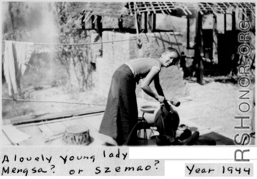 Lovely young lady in Mengsa or Szemao laddling liquid from an earthenware container. 1944.