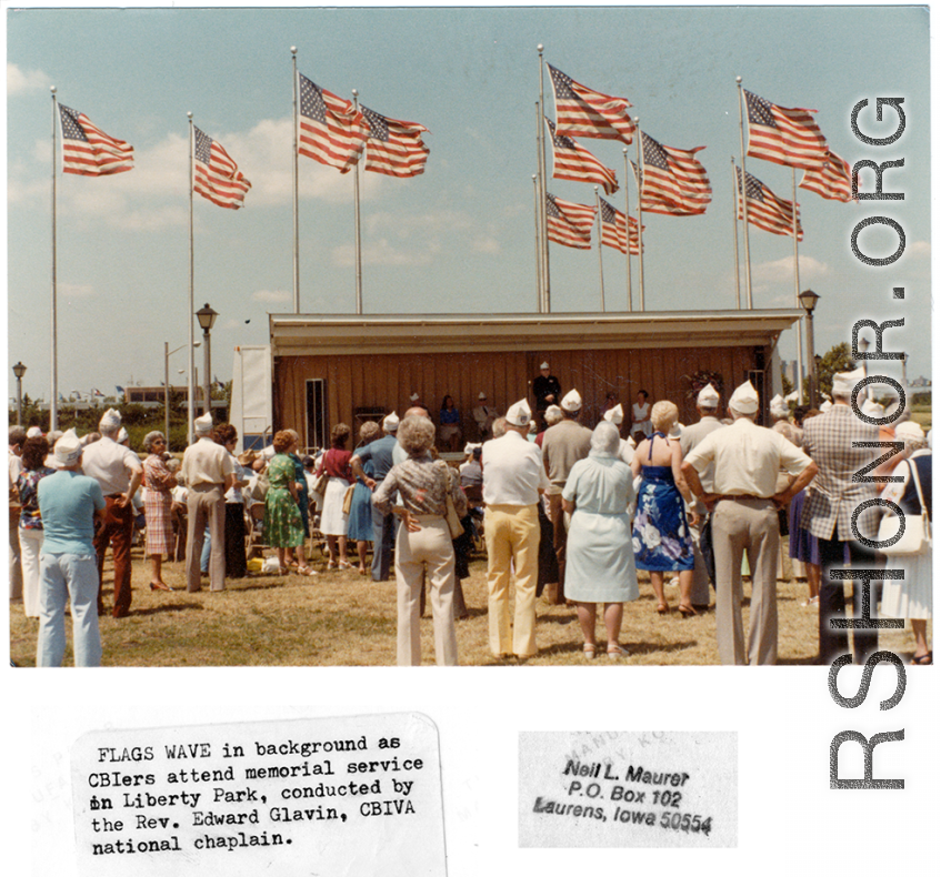 US flags wave at a modern memorial service at Liberty Park, conducted by CBIVA national chaplain, the Rev. Edward Glavin.  Photo from Neil L. Maurer.