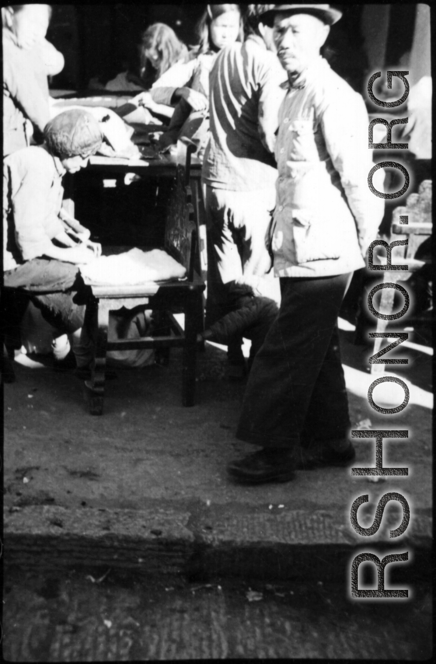 People busy on a street in China during WWII.