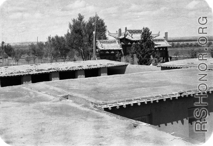 Flat mud roofs and ceremonial arch in northern China. 