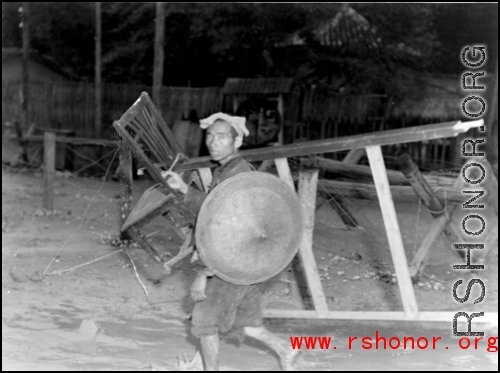 People transporting possessions in Guangxi province during WWII, possibly in preparation to fleeing in the face of the Japanese Ichigo campaign.