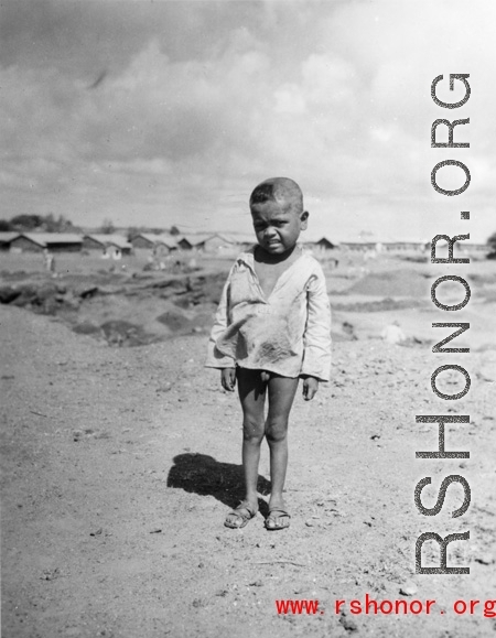 Local people in China, Burma, India: A small child near an American base in China during WWII.