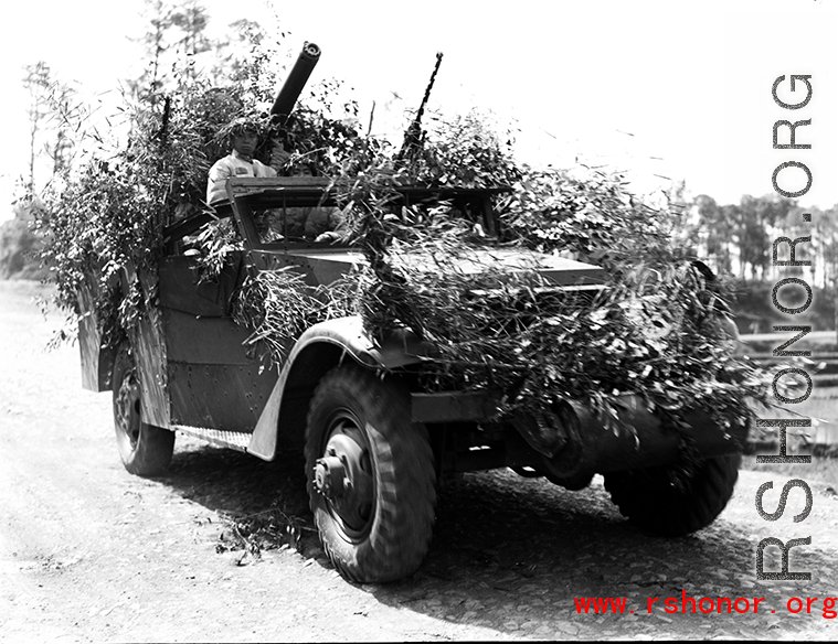 Chinese soldiers with equipment ready and covered in camouflage during exercises in southern China, in Yunnan province.  Despite the appearance of being on their way to battle, these men are more likely in fact prepared for a demonstration or honor parade. 