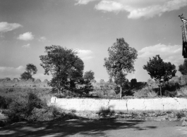 A fortress wall behind a village house in a village in Yunnan province, China.