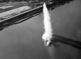 A solitary bomb falls from low altitude in a river, mostly during a run on a bridge, and most likely in French Indochina. During WWII.