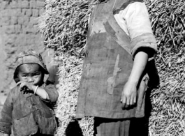 Local people in China, probably in Yunnan province: Woman and child village.