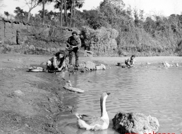 Local people in a village near Yangkai, Yunnan province, China, was items in a pond. During WWII.