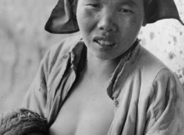 A nursing mother and child in China during WWII.