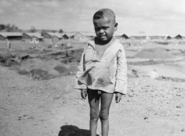 Local people in China, Burma, India: A small child near an American base in China during WWII.