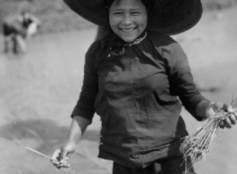 Local people in China: A woman in Yunnan transplants rice seedlings. During WWII.