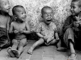 Local kids in China during WWII, including one who is very upset about something. During WWII.
