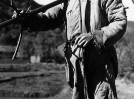 Local people in China: A Chinese farmer in Yunnan poses with a farming implement. During WWII.