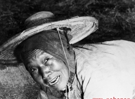 Local people in China: An elderly woman works in the farm fields during WWII.