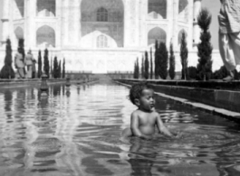 A kid playing in reflecting pool at Taj Mahal during WWII.