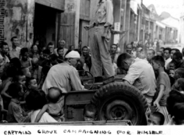 Capt. Grove campaigning for himself for mayor in a small town we passed through, from atop his jeep. Croughan on left, Capt. Penick on right.  Near an American base in Guangxi province (either Guilin or Liuzhou), China, during WWII.