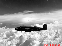 B-25 Mitchell bomber in flight in the CBI, in the area of southern China, Indochina, or Burma. During WWII.