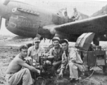 "This is another of the eight P-40's that were built from the salvage yard at Kwelin,China.The guys that are running an air speed indicator test are Art Rodriguez...Major Matthews...?...Joe Cooper. Joe was the crew chief on this project."   Notation of the nose of the plane seems to say "DEVIL'S KID" and "Mikado Raider II."