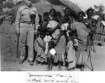 A GI with local people in India during WWII.    From the collection of David Firman, 61st Air Service Group.