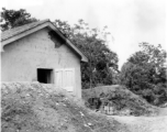 A newly built building at a base in China during WWII. Note the raise protective berm around the building, to protect from bomb blasts, etc.