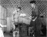 Iron smiths in China forge a large steel rod during WWII.