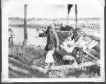 Scenes in Kunming, China, area during WWII: Boy with ox, and people getting off boat on canal.