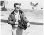 Aerial Photographer Earnest Jones, holding camera.