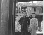 Local boys stand in the entry to a courtyard at Chanyi (Zhanyi) during WWII.