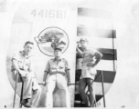 American flyers with tail assembly of a F-7A/B-24, showing The Wily Wolves insignia. October 4, 1945, Gushkara, India.  Lt. Willhoite, Lt. W. J. Rumler, Lt. "Mike" Howes.  24th Combat Mapping Squadron, 8th Photo Reconnaissance Group, 10th Air Force.