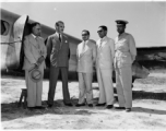 VIPs stand by airplane, likely in India.
