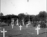 GIs visit an American graveyard.   William Pribyl, 961st Petroleum Products Laboratory.