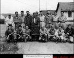 "Communications ground maintenance." Men of the 27th Troop Carrier Squadron surround a large radio unit with tall antenna in the CBI (most likely China).