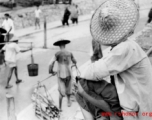People along the ramp to the floating bridge to Liuzhou city, Guangxi province, during WWII.