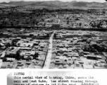 During WWII, this aerial view of Kunming, China, shows the wall and West Gate.  The street running through center of picture is Sui Ching Road.  6/21/1945