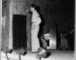 A GI stands at the microphone during entertainment of the CBI, as the Jive-o-Lieps are ready at their instruments. During WWII.