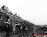 Fleeing people on (and on-top) of train during Chinese civilian evacuation in Guangxi province, China, during WWII, during the summer or fall of 1944 as the Japanese swept through as part of the large Ichigo push. During WWII.